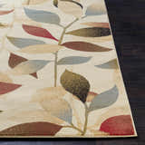Close-up of the Ober Fall Leaves Rug. Machine-woven polypropylene rug with a leaf pattern in red, brown, green, and blue on a cream background. Front