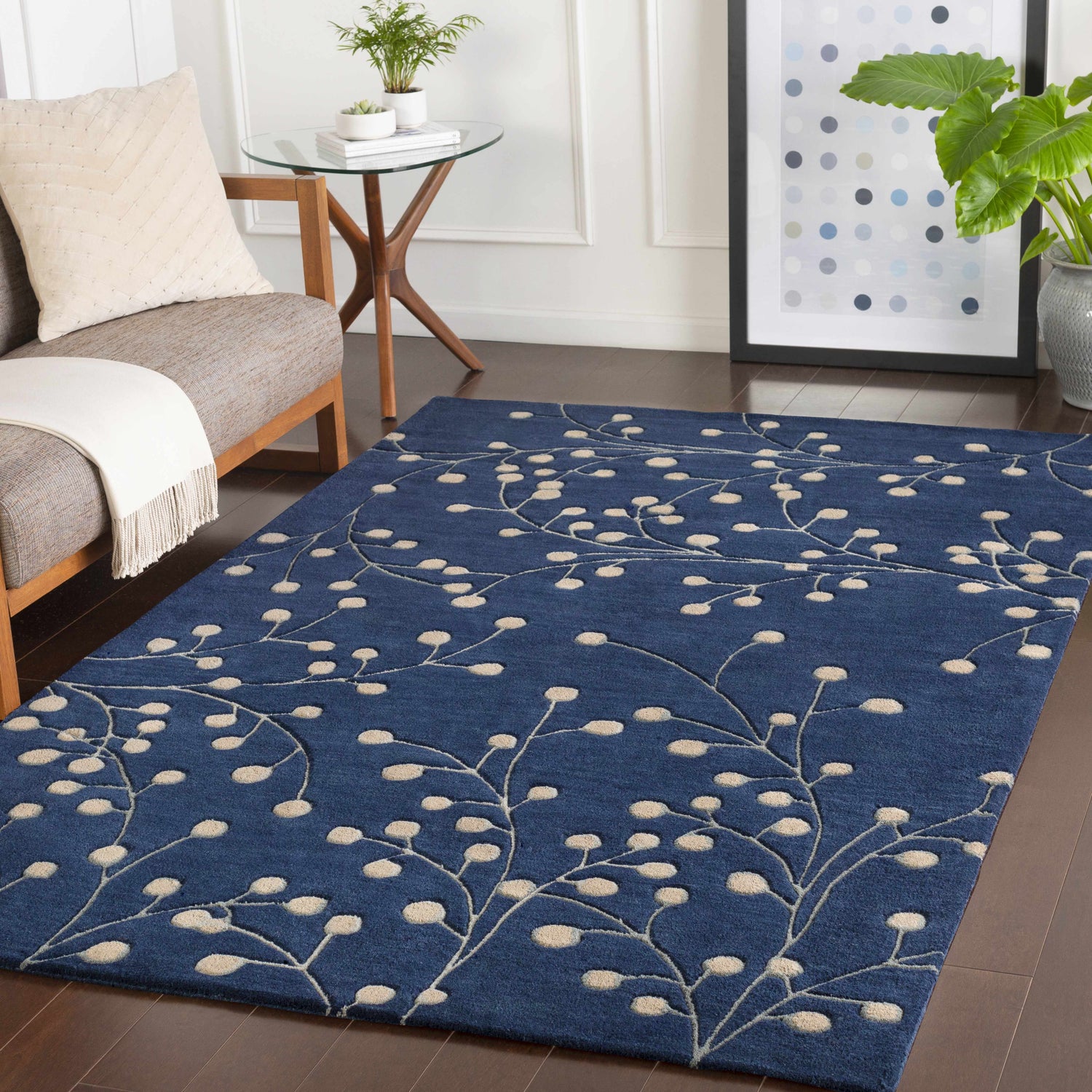 Living room scene with a blue Elsu Area Rug featuring a tan floral pattern on dark wood floors. Roomscene-Rectangle