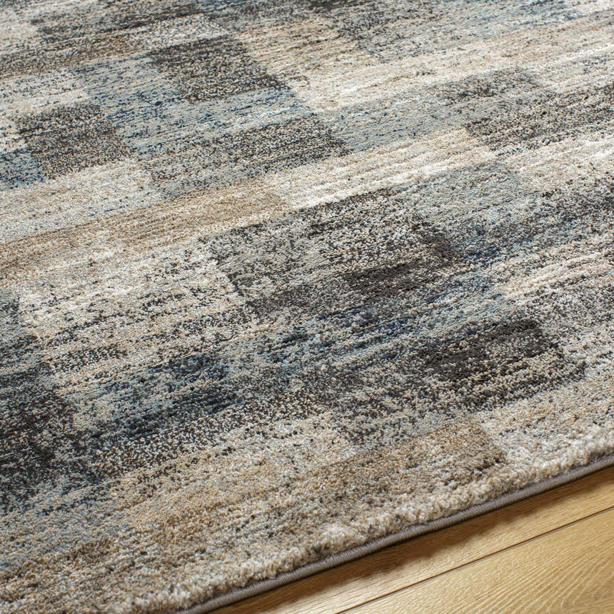 Close-up of the Ohtli Mosaic Luxe Thick Area Rug. Southwestern style rug in gray, smoke, and tan mosaic pattern. Texture