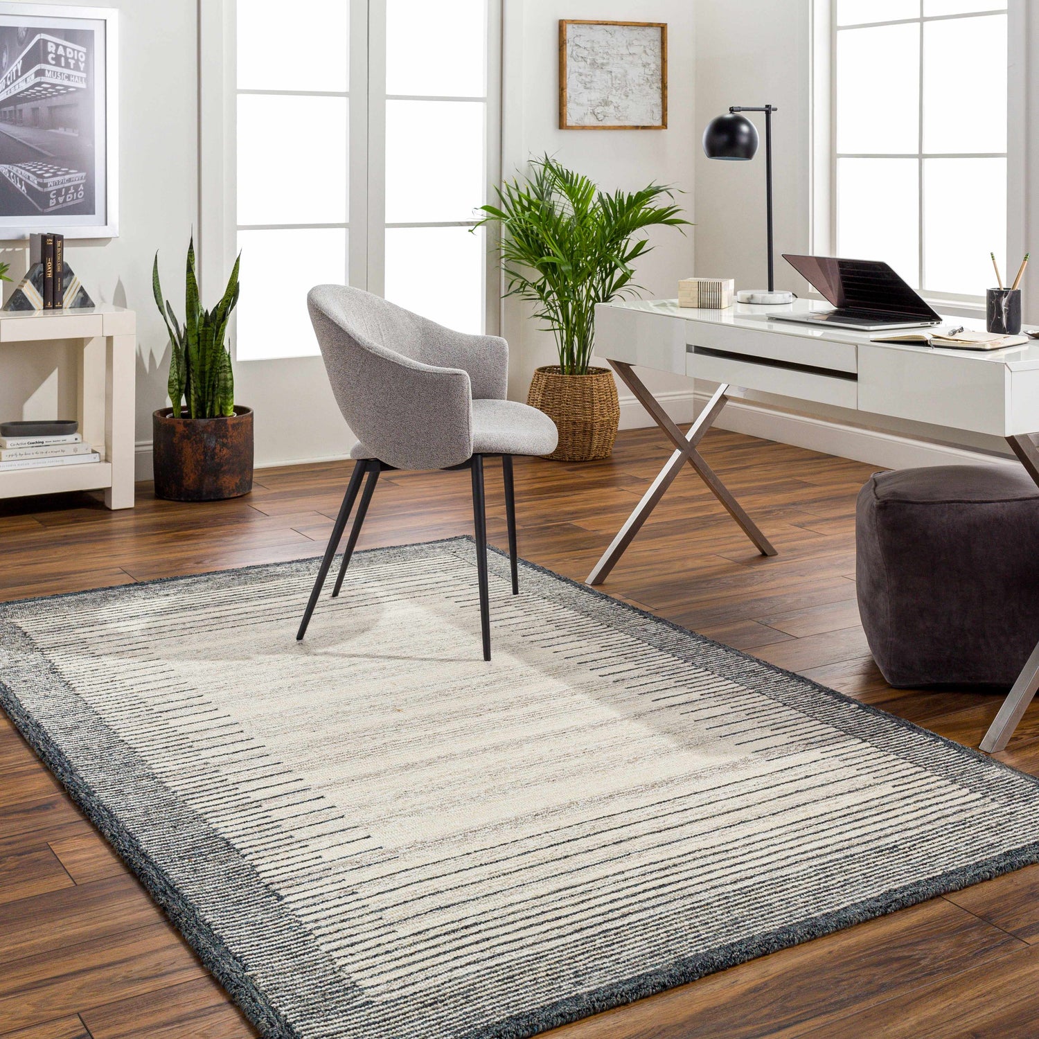Home office with Omeo Wool Area Rug in bone and dark gray, gray chair, white desk, and wood floors. Roomscene-Rectangle