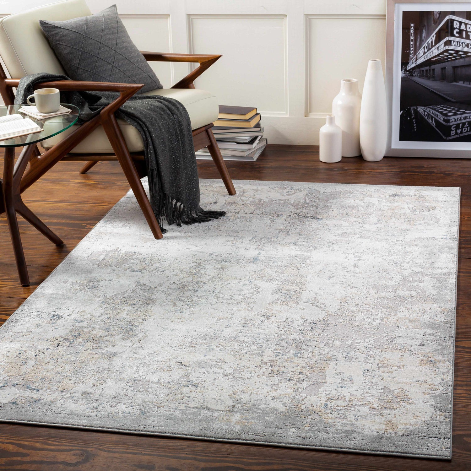 Living room scene with a light beige Ooralea Area Rug, chair, side table, and wood floors. Contemporary style. Roomscene-Rectangle