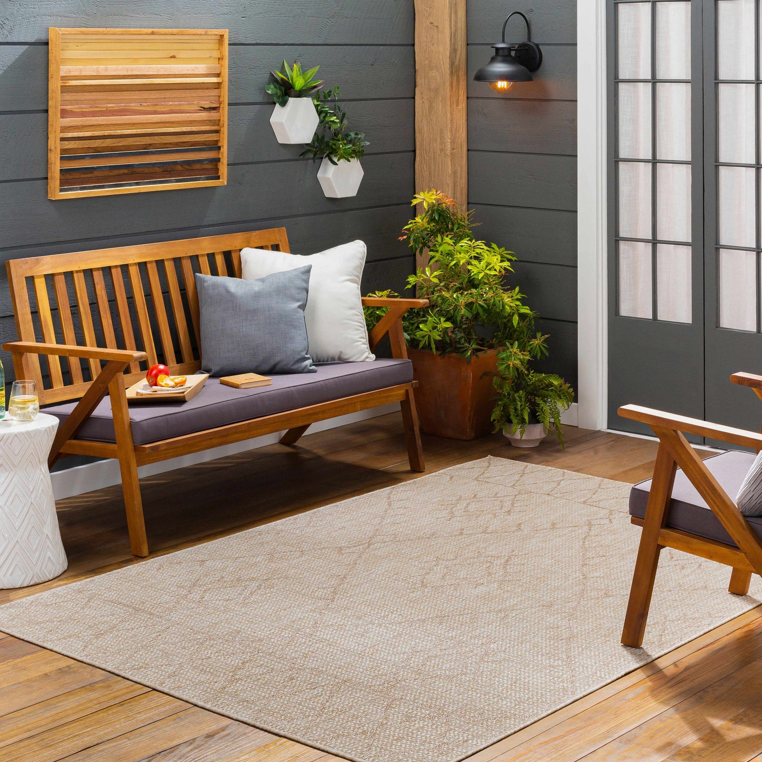 Cozy patio scene with a Marwood Brown Nordic Rug, wood bench, and gray accents. Perfect outdoor living space. Roomscene-Rectangle