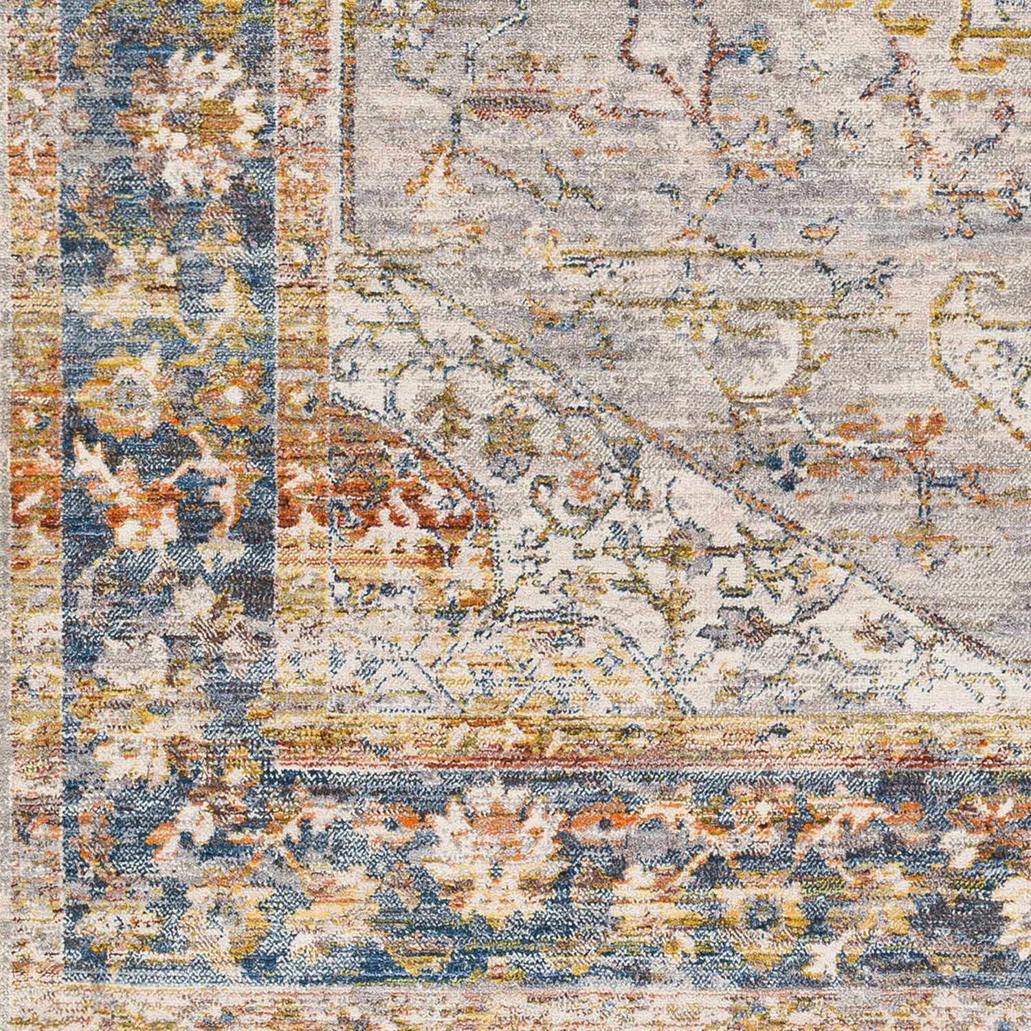Close-up of the Orchards Area Rug: a machine-woven rug with brick red, burnt orange, blue, and gray bohemian-style patterns. Swatch