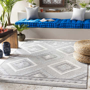 Bright sunroom with blue cushions and the gray and cream Oreana Area Rug. Roomscene-Rectangle