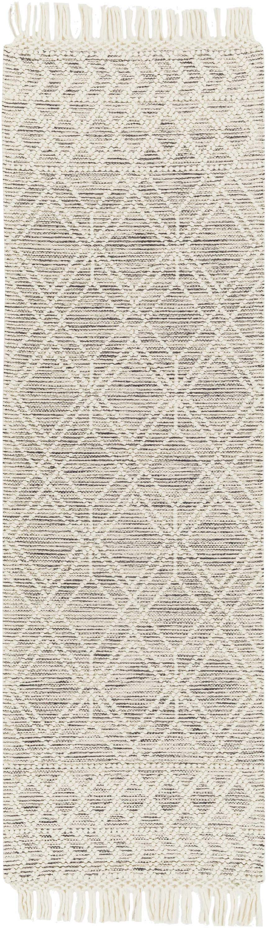 Close-up of the Ossun Wool Rug. Cream rug with black geometric pattern and tassels. Farmhouse style. Design-Runner-268