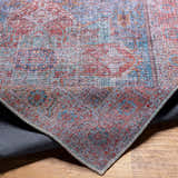 Close-up of the Otaki Washable Area Rug showing its traditional oriental pattern and colors: dark gray, purple, brown, and natural gray. Fold
