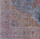 Close-up of the Otaki Washable Area Rug, showcasing its dark gray, purple, brown, and natural hues in a traditional pattern. Swatch