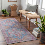 Entryway with wood floors and Otaki Washable Area Rug in dark gray, purple, brown, and natural tones. Bench and plants. Roomscene-Runner