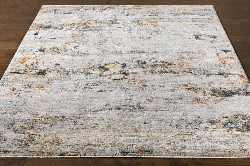Close-up of the Ottawa Luxe Rug. Contemporary design with brick red, cream, dark blue, and gray hues. Front