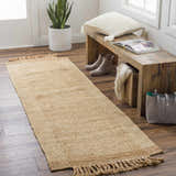Entryway scene with a light brown Outaouais Jute Rug runner, wooden bench, boots, and a tote bag. Roomscene-Runner