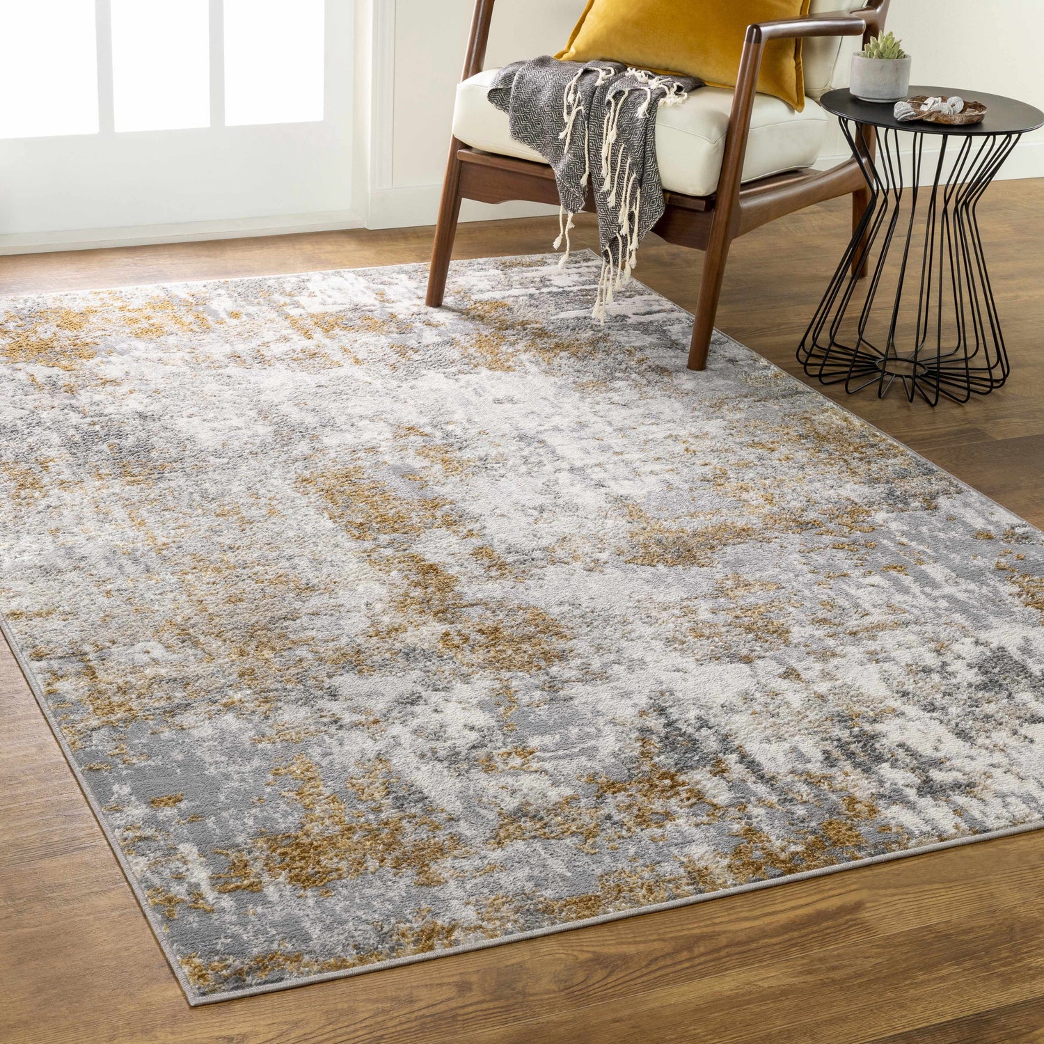 Living room scene with a camel, charcoal, and gray Pagbilao Runner under a chair and side table. Roomscene-Rectangle