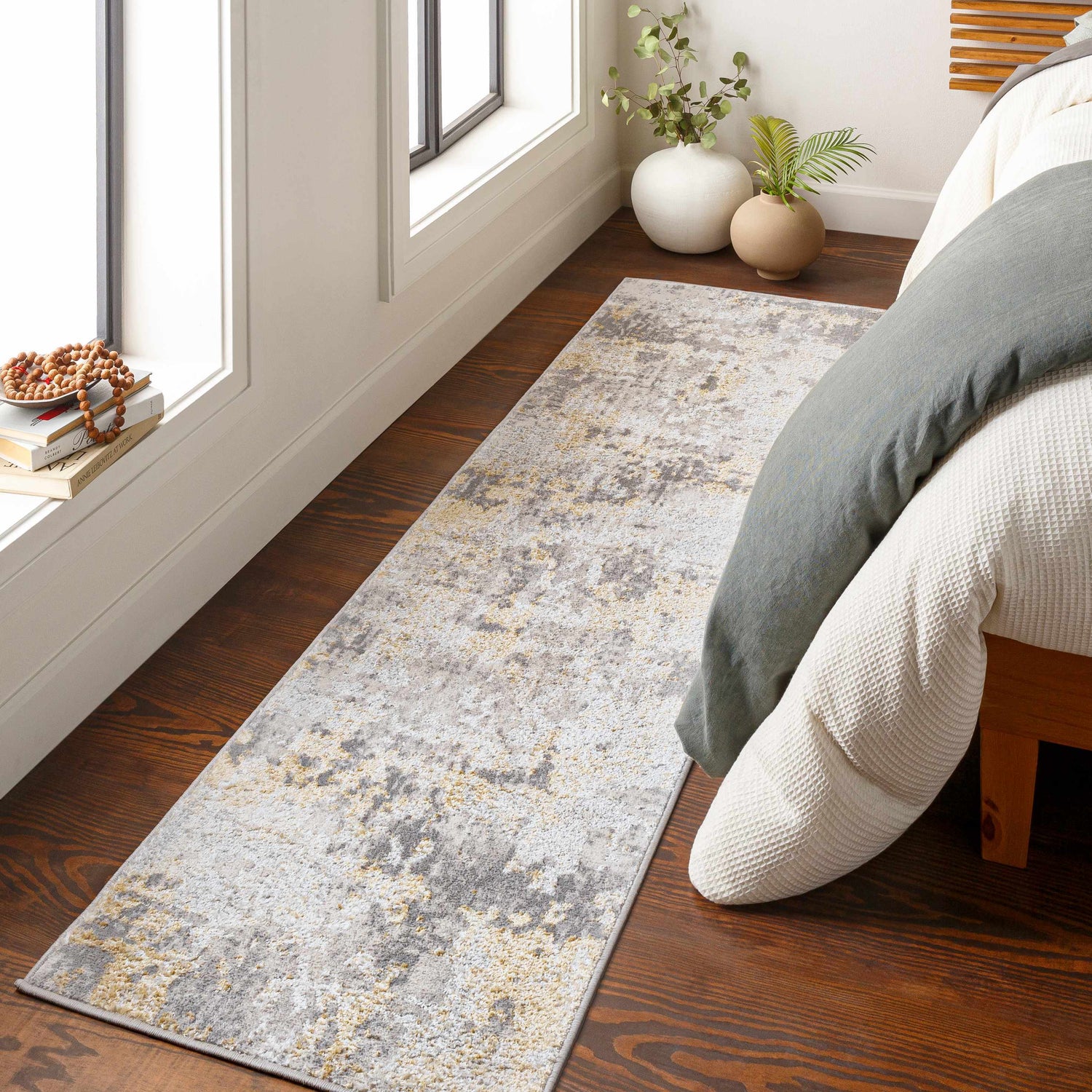 Bedroom scene with a camel, charcoal, and gray Pagbilao Runner rug on hardwood floors. Roomscene-Runner