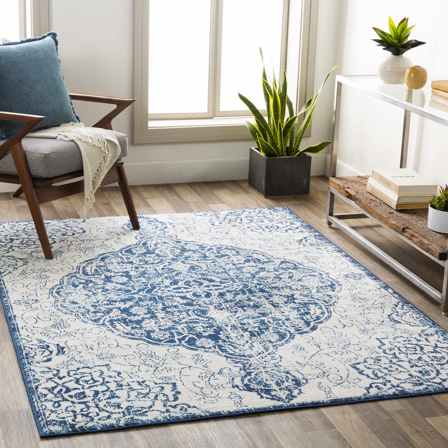 Living room scene with blue and beige Pannal Area Rug, mid-century chair, and plants. Bright, contemporary style. Roomscene-Rectangle