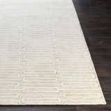 Close-up of the Partlow Area Rug. Beige and cream viscose rug with a contemporary geometric pattern. Front