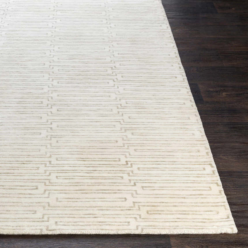 Close-up of the Partlow Area Rug. Beige and cream viscose rug with a contemporary geometric pattern. Front