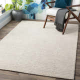 Contemporary mudroom with a beige Partlow Area Rug, cream chair, and blue accents. Roomscene-Rectangle