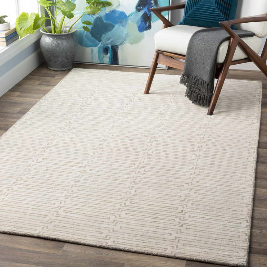 Contemporary mudroom with a beige Partlow Area Rug, cream chair, and blue accents. Roomscene-Rectangle