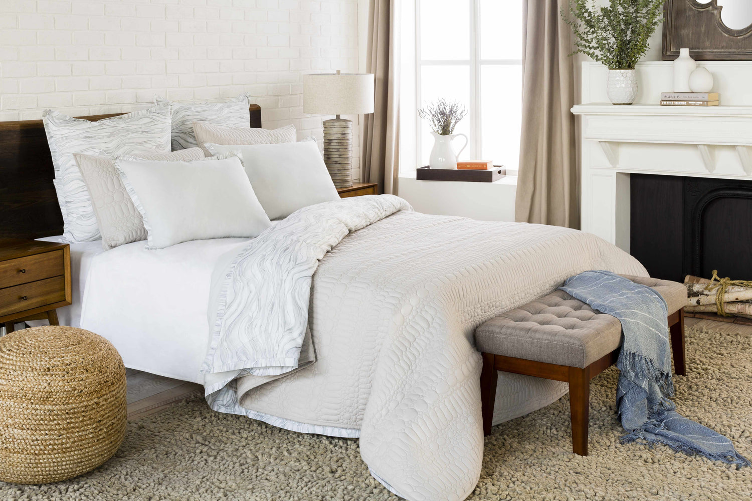 Bedroom scene with a cream Oakridge Area Rug, white bedding, and a cozy, neutral color palette. Roomscene-Rectangle