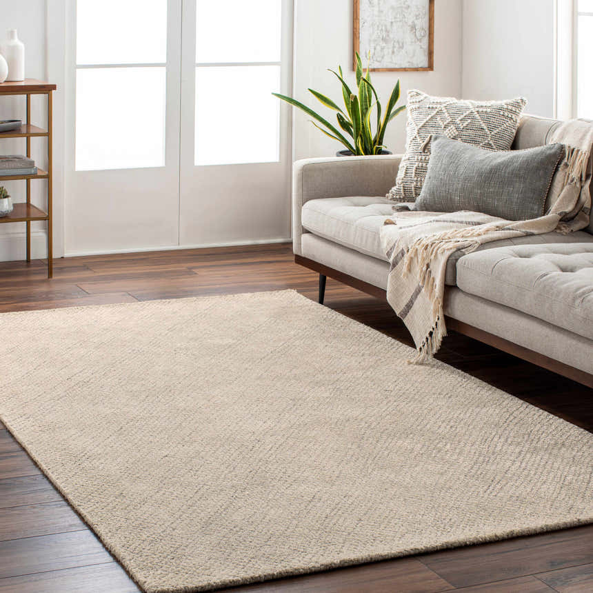Living room scene with a tan Phalaborwa Area Rug, gray sofa, and wood floors. Roomscene-Rectangle