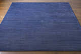 Close-up of the dark blue Philipsburg Carpet showing its subtle texture and hand-knotted construction. Front