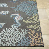 Close-up of Pasca Charcoal Area Rug showing coastal design with blue seahorse, starfish, shells, and coral on a charcoal background. Front