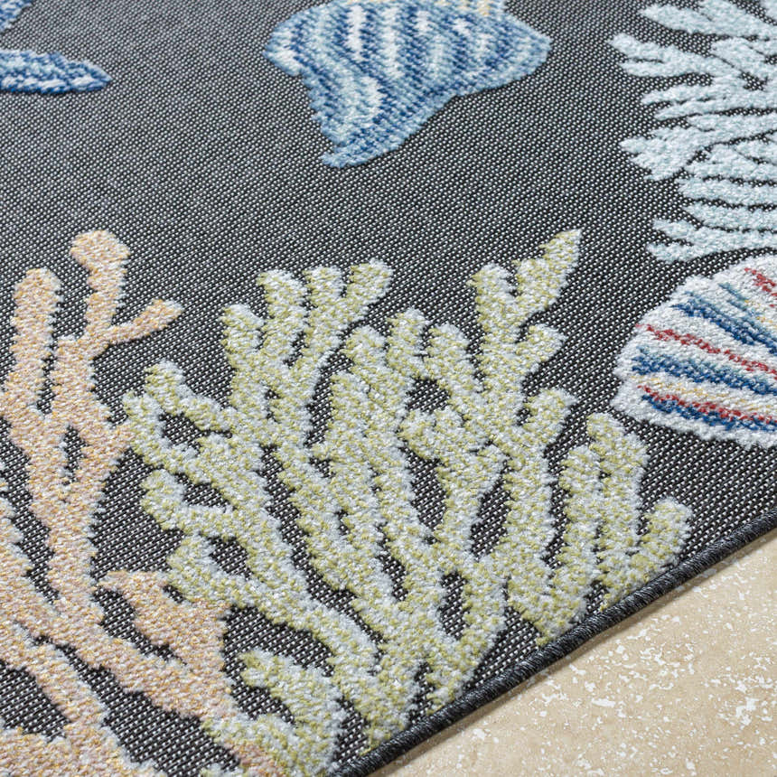 Close-up of Pasca Charcoal Area Rug with coastal design. Blue fish, olive coral, and tan coral on a charcoal background. Texture