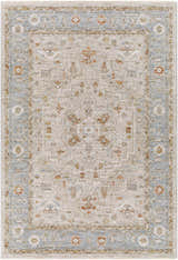 Close-up of the Phyllis Thick Luxe Statement Rug, showcasing traditional patterns in light beige, denim, and brick red hues. Design-Rectangle-575
