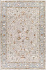 Close-up of the Phyllis Thick Luxe Statement Rug. Features traditional patterns in light beige, denim blue, and brick red. Design-Rectangle-6796