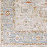 Close-up of the Phyllis Thick Luxe Statement Rug. Features light beige, blue, and orange traditional-style patterns. Swatch