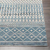 Close up of the Pinamopoan Washable Area Rug in blue, gray, and beige with a contemporary geometric pattern. Front