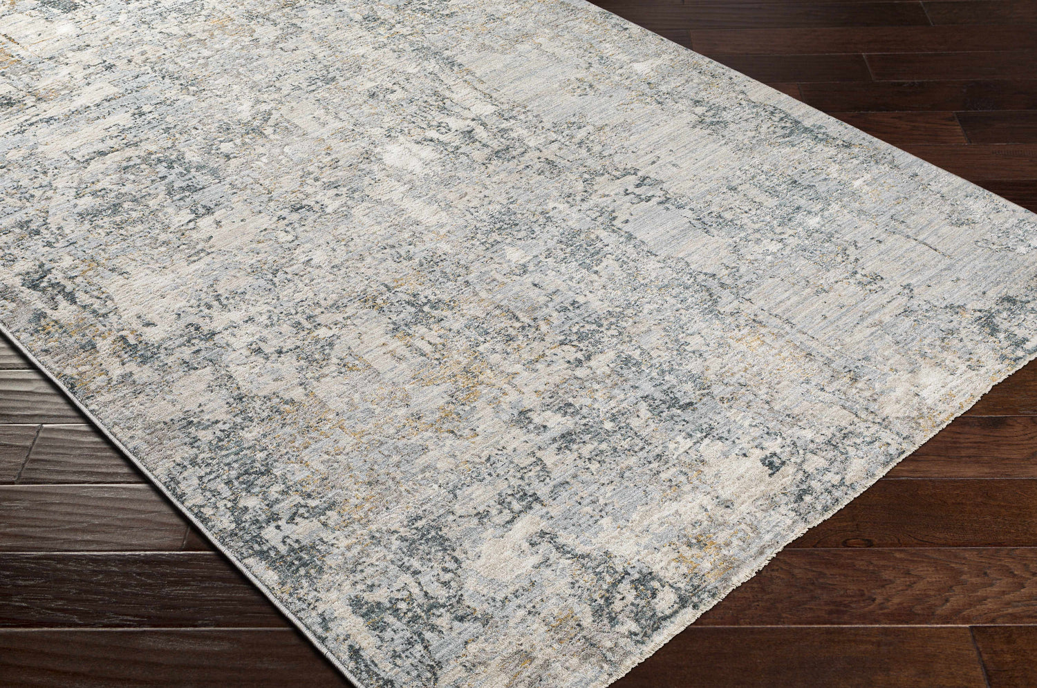Close-up of the Pinjarra Luxe Rug showing its charcoal, cream, and gray contemporary design and soft polyester texture. Corner