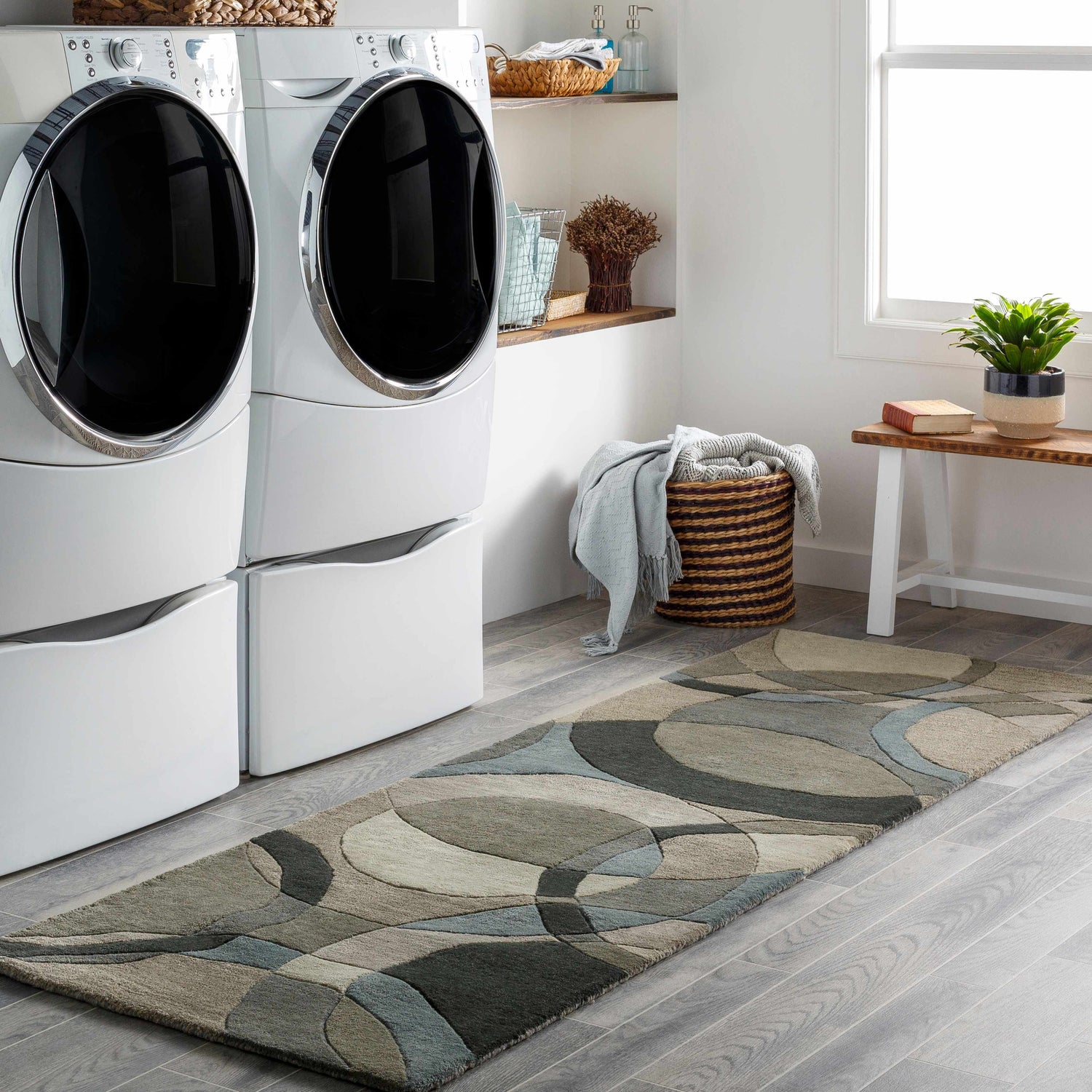 Laundry room scene with gray wood floors and a Rilton Gray Wool runner rug with black, charcoal, gray, taupe, and teal geometric shapes. Roomscene-Runner