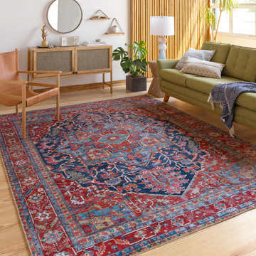 Living room scene with a Pauline Red Medallion Performance Rug, green sofa, wood accents, and natural light. Roomscene-Rectangle