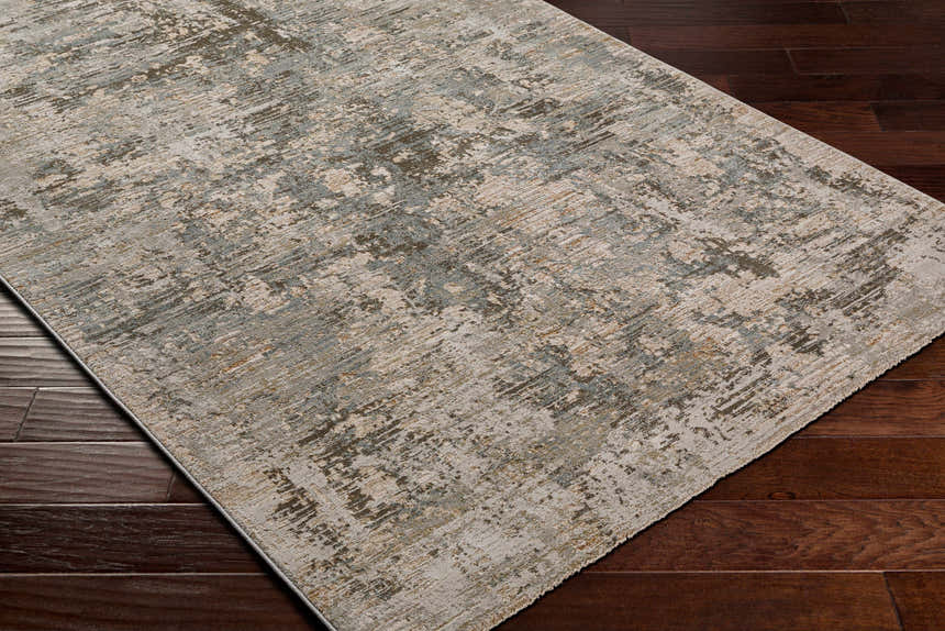 Close-up of the Palanit Thick Luxe Boutique Rug, showcasing its abstract design with beige, gray, teal, and brown tones. Corner
