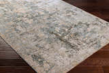 Close-up of Palanit Thick Luxe Boutique Rug with a contemporary abstract design in light beige, teal, gray, and olive tones. Corner