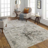 Living room scene with a Palanit Thick Luxe Boutique Rug in gray, beige, and charcoal tones. Neutral furniture and wood floors. Roomscene-Rectangle