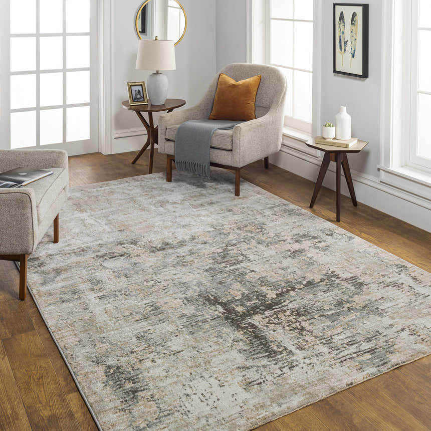Living room scene with a Palanit Thick Luxe Boutique Rug in gray, beige, and charcoal tones. Neutral furniture and wood floors. Roomscene-Rectangle