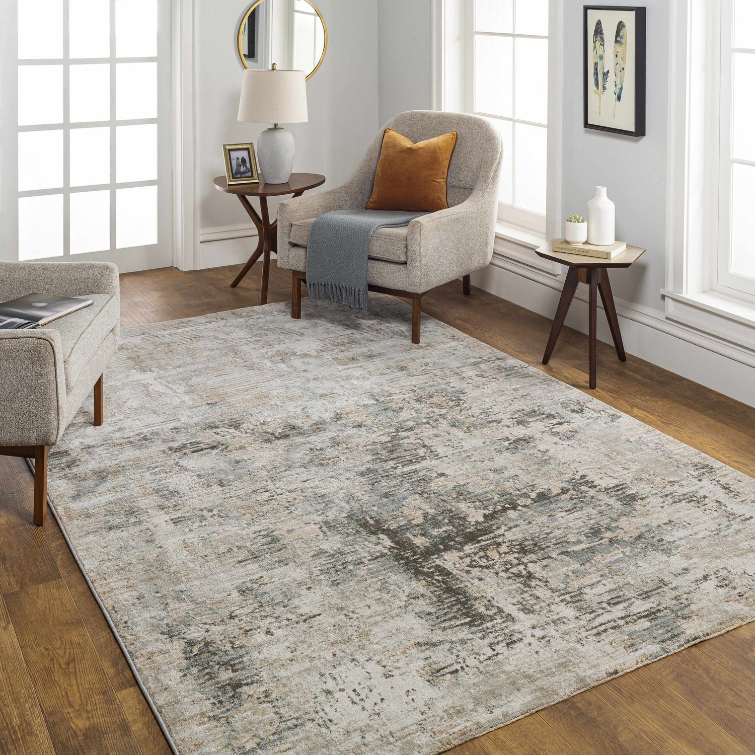 Living room scene with a Palanit Thick Luxe Boutique Rug in gray, beige, and charcoal tones. Neutral furniture and wood floors. Roomscene-Rectangle