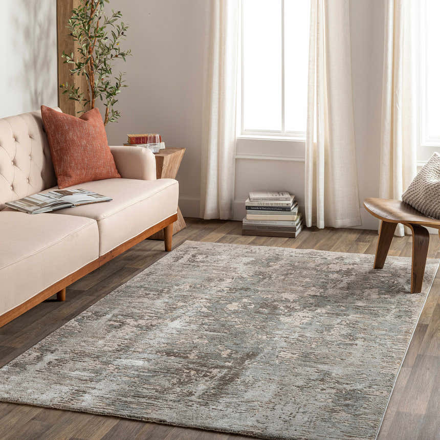 Living room scene with a beige sofa and the Palanit Thick Luxe Boutique Rug in gray, beige, and teal tones. Contemporary style. Roomscene-Rectangle