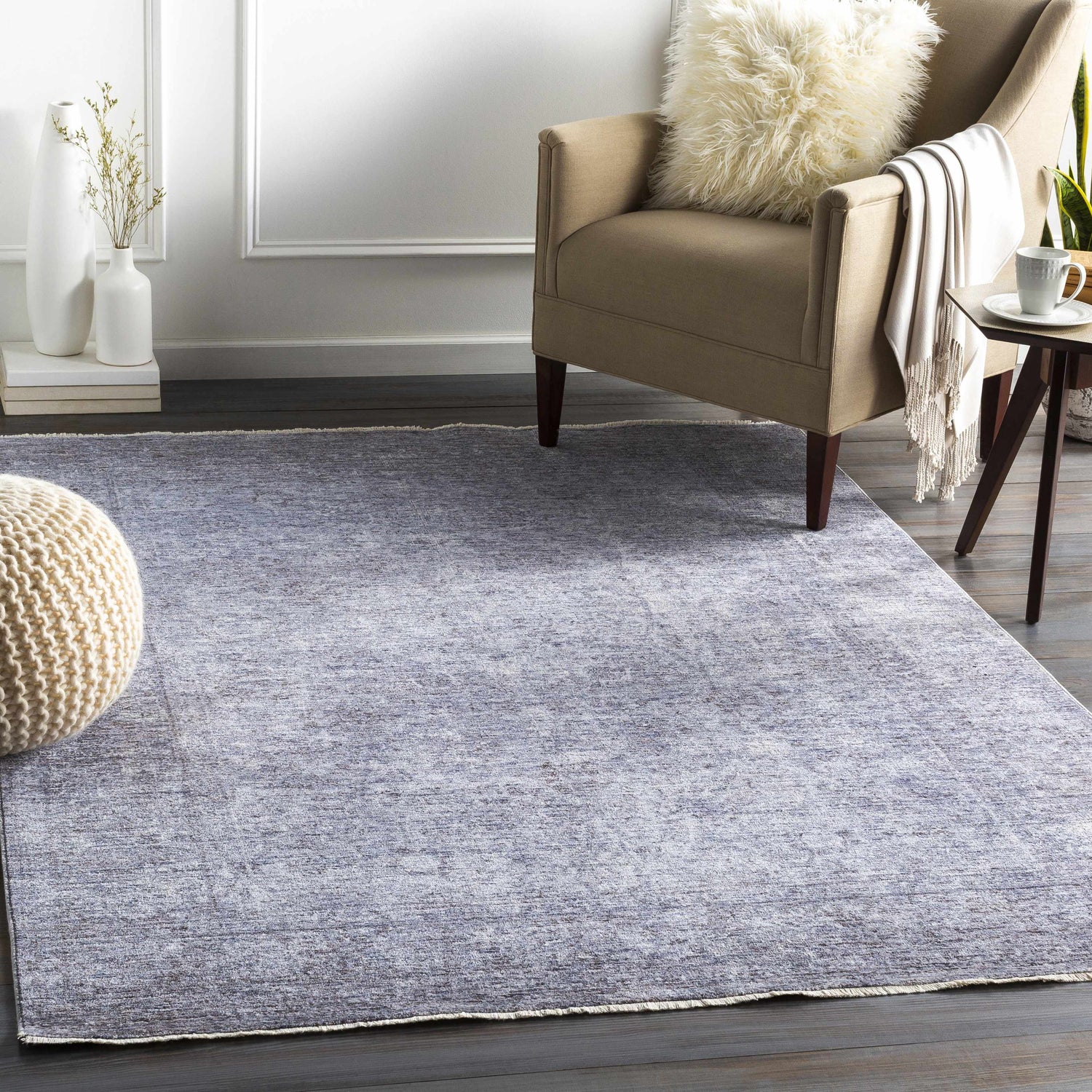 Living room scene with a blue Plympton Carved Statement Rug, beige armchair, and ivory accents for a cozy, transitional style. Roomscene-Rectangle