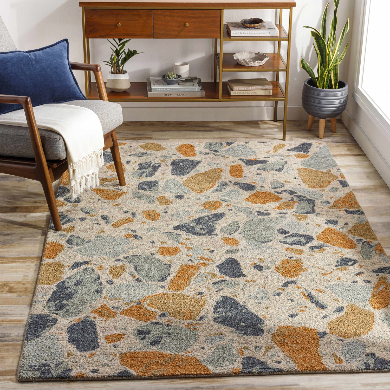 Living room scene with mid-century modern furniture and a Panabingan Area Rug in brick red, beige, blue, and brown. Roomscene-Rectangle