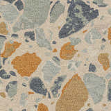 Close-up of the Panabingan Area Rug showing a brick red, blue, and beige abstract pattern on hand-tufted wool. Swatch