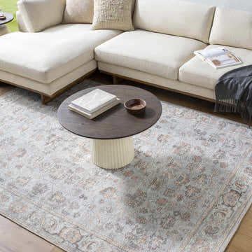 Living room scene with cream sectional and Livabliss x Our PNW Home Olympic Damask Light Blue Rug. Roomscene-Rectangle