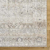 Close-up of the PNW Home Rainier Damask Light Brown Washable Rug showing its traditional pattern and light brown, tan colors. Corner