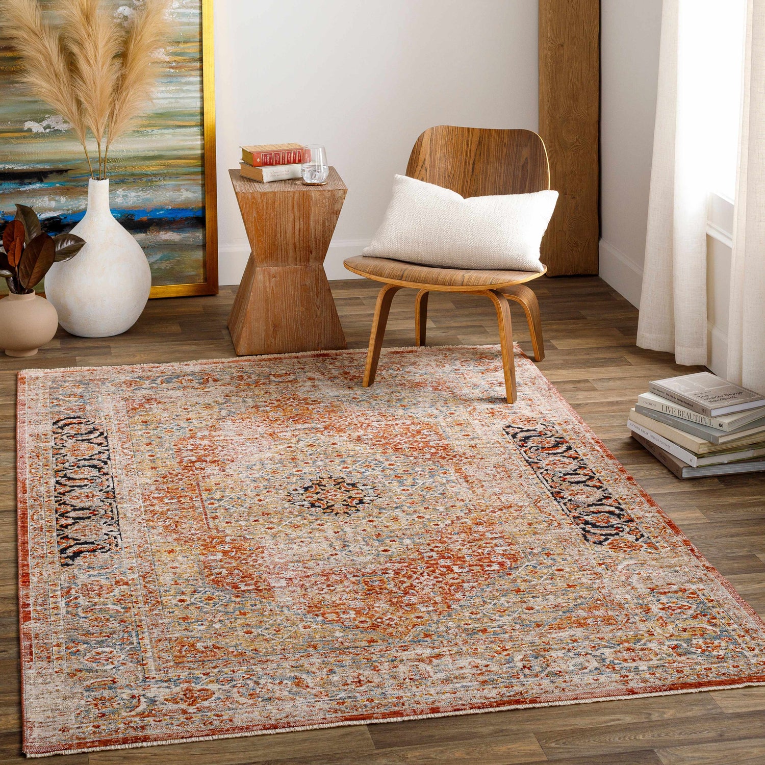 Living room scene with a brick red Polomolok Luxe Performance Rug, wood chair, side table, and neutral decor. Roomscene-Rectangle