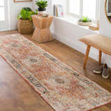 Hallway scene with a brick red Polomolok Luxe Performance Rug runner, wooden bench, plants, and natural light. Roomscene-Runner
