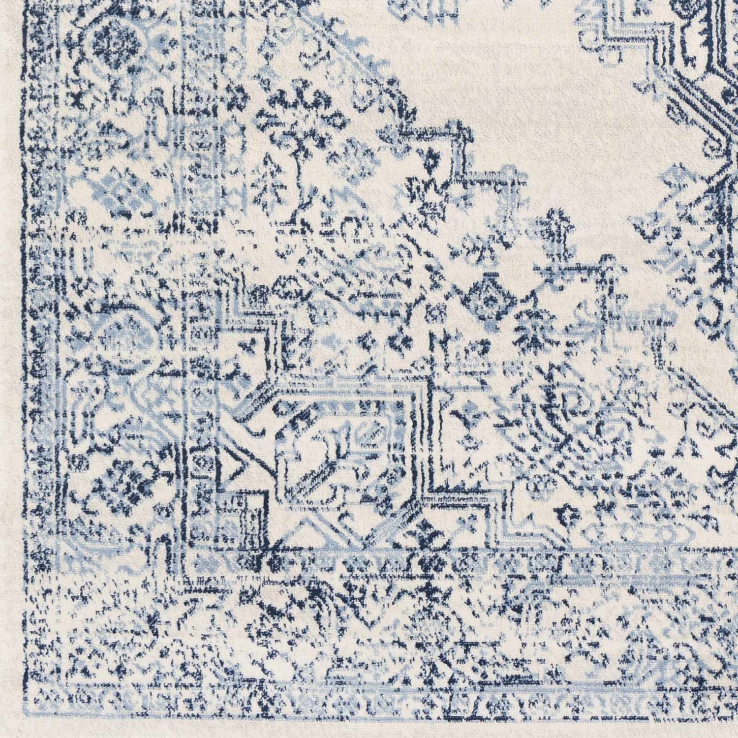 Close-up of the Pooraka Area Rug. Off-white rug with a traditional navy and light gray oriental pattern. Swatch