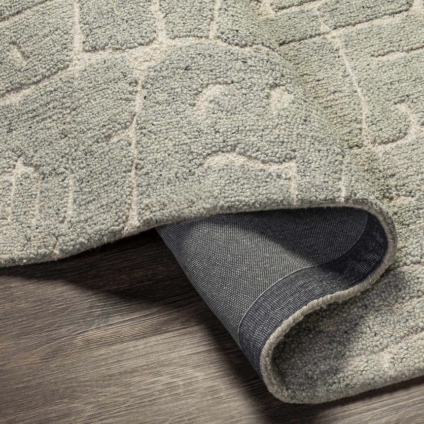 Close-up of the hand-tufted Posof Area Rug. Light beige and gray wool rug with a contemporary geometric pattern. Fold