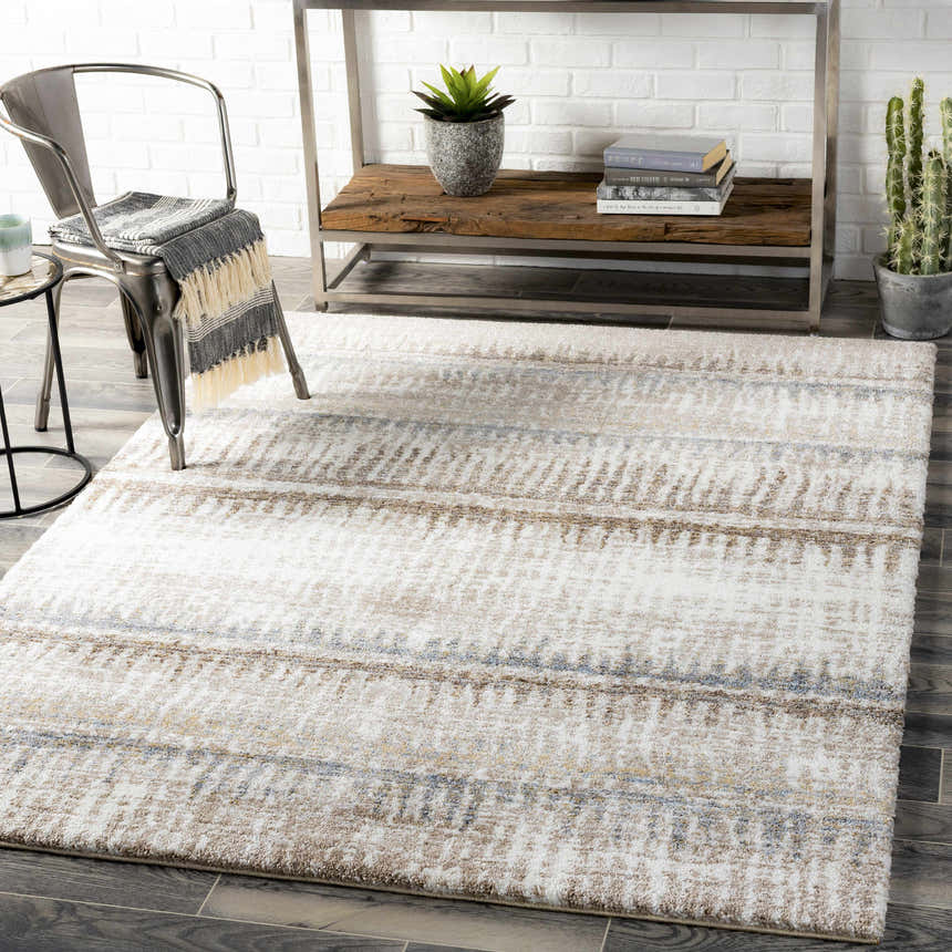 Living room scene with Prees Area Rug in cloud gray, cream, and brown. Contemporary style with metal chair and wood shelving. Roomscene-Rectangle