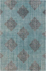 Close-up of the hand-knotted Presidio Area Carpet. Emerald background with black diamond medallion pattern. 100% wool texture. Design-Rectangle